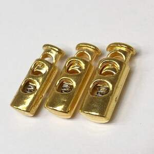 Фиксатор для шнура пластиковый 23 мм, цвет золото